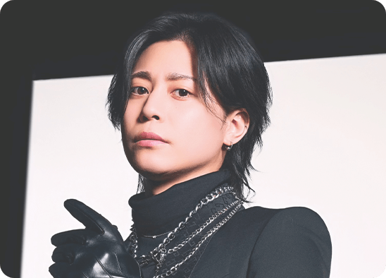 紫の背景で黒いスーツを着た松岡汰我のポートレート写真。腕時計を身につけ、上品でスタイリッシュな印象を与えるプロフィールイメージ。